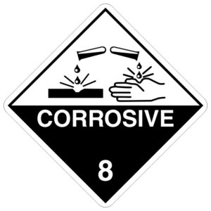 A diamond-shaped hazard sign with a black and white background, showing a symbol of two test tubes spilling liquid onto a metal surface and a hand, illustrating a corrosive reaction. The sign features the word 'CORROSIVE' and the number '8', representing Class 8 dangerous goods as per the Australian Dangerous Goods Code. These substances are highly corrosive and can cause severe damage to skin, eyes, and metals, necessitating strict handling and storage protocols to prevent harm, as outlined in AS3780 standards.