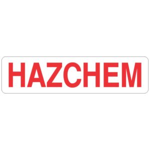 A rectangular sign with the word 'HAZCHEM' written in bold red capital letters on a white background, indicating the presence of hazardous chemicals.