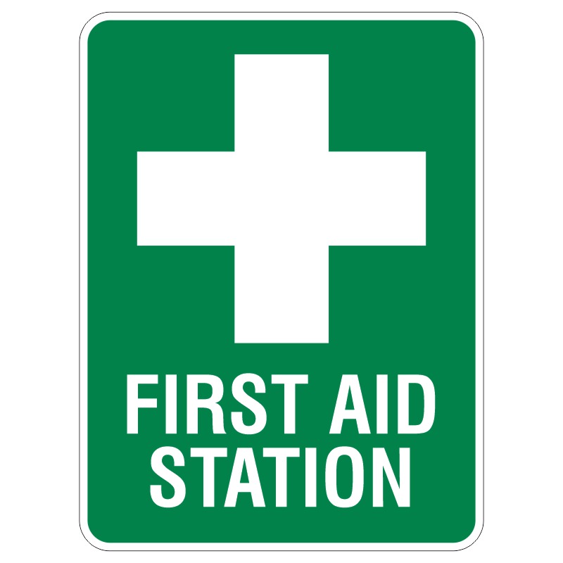 A green sign displaying a white medical cross and the words FIRST AID STATION in bold letters.