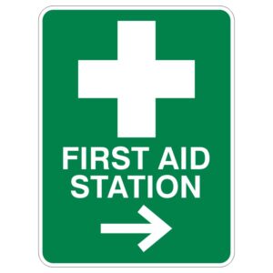 A green sign with a white cross above the words FIRST AID STATION and an arrow pointing to the right.