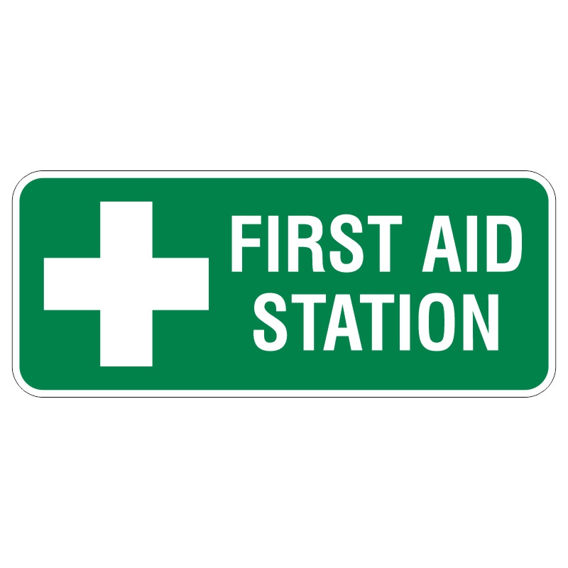 A green sign displaying a white cross symbol and the text FIRST AID STATION in bold white letters.
