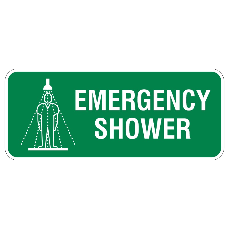 A green sign displaying the words EMERGENCY SHOWER with a graphic illustration of a person standing under a showerhead, signifying the location of an emergency shower.