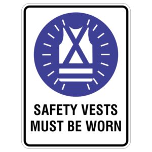 A safety sign featuring a graphic of a safety vest inside a blue circle, with the text SAFETY VESTS MUST BE WORN in bold black letters below it.