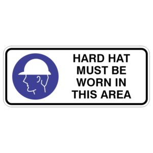 A safety sign with a blue circle featuring a profile of a person wearing a hard hat, accompanied by the text HARD HAT MUST BE WORN IN THIS AREA in bold black letters.