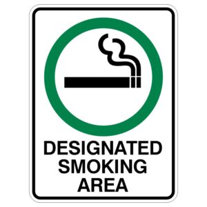 A sign indicating a designated smoking area, featuring a green circle around a black cigarette icon with smoke above it, and the words DESIGNATED SMOKING AREA at the bottom.