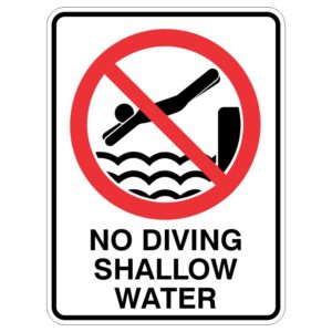 A no diving sign featuring an image of a person diving into waves, encircled with a red prohibition symbol, and text below stating NO DIVING SHALLOW WATER.