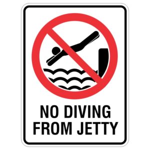 A safety sign featuring a red circle with a diagonal line over an illustration of a person diving into waves, accompanied by the text NO DIVING FROM JETTY underneath.