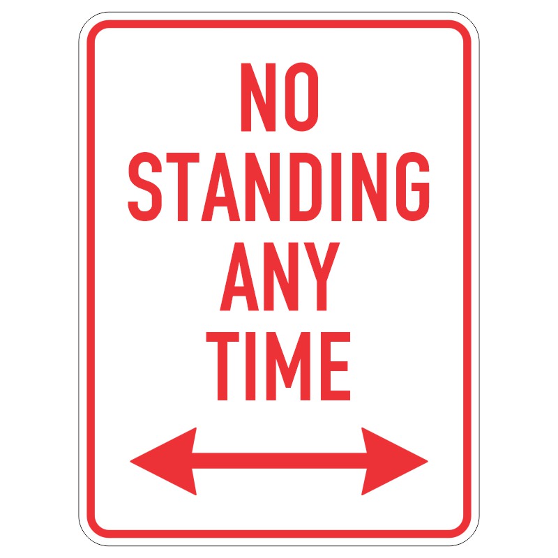 A white sign with bold red text stating NO STANDING ANY TIME flanked by two red arrows pointing left and right.