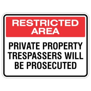 A sign indicating a restricted area, with red letters stating 'RESTRICTED AREA' at the top and black text below reading 'PRIVATE PROPERTY TRESPASSERS WILL BE PROSECUTED'.