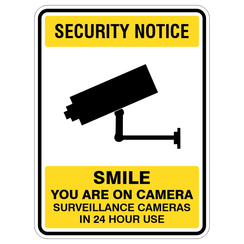 A security notice sign featuring a black silhouette of a surveillance camera, with the text 'SECURITY NOTICE' at the top, followed by 'SMILE YOU ARE ON CAMERA' and 'SURVEILLANCE CAMERAS IN 24 HOUR USE' at the bottom, all on a yellow background.