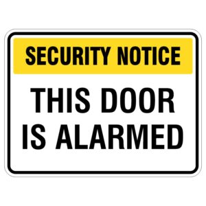 A rectangular security notice sign with a yellow header and black text stating "SECURITY NOTICE" and THIS DOOR IS ALARMED, indicating that the door is secured with an alarm system.