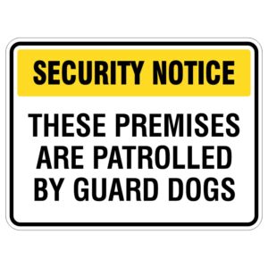 A security notice sign with a yellow header stating 'SECURITY NOTICE' and black text below reading 'THESE PREMISES ARE PATROLLED BY GUARD DOGS.'