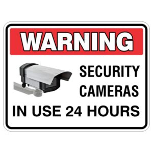 A warning sign indicating that security cameras are in use 24 hours, featuring an illustration of a security camera next to the bold text 'WARNING SECURITY CAMERAS IN USE 24 HOURS'.