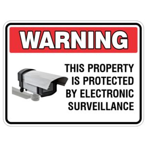 A rectangular warning sign with a red header reading 'WARNING', stating that the property is protected by electronic surveillance, accompanied by an illustration of a security camera.