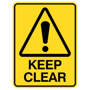 A warning sign with a yellow background featuring a black triangular hazard symbol and an exclamation mark above the words 'KEEP CLEAR' in bold black lettering.